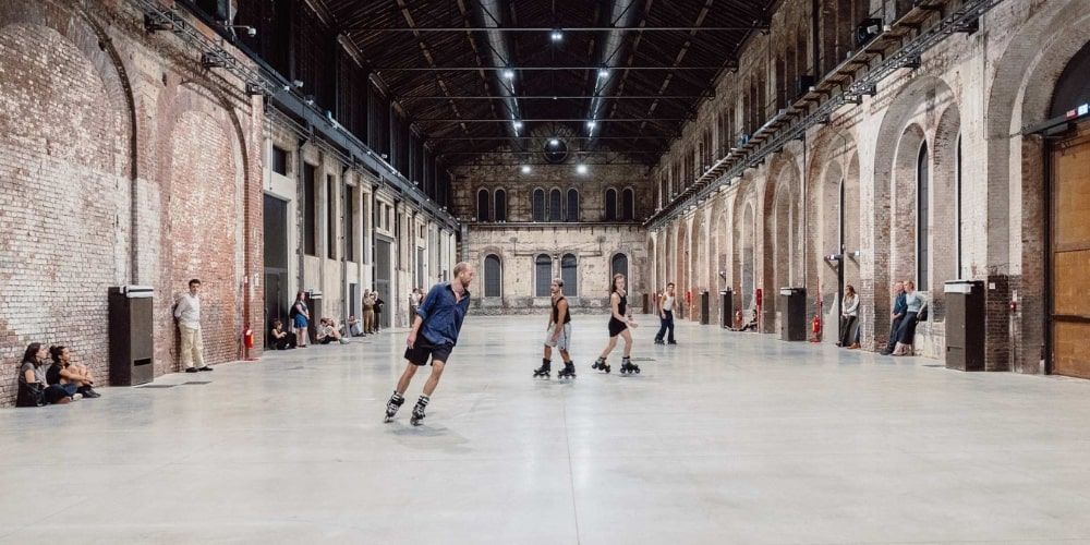 Skaters in the historic industrial halls of OGR Torino